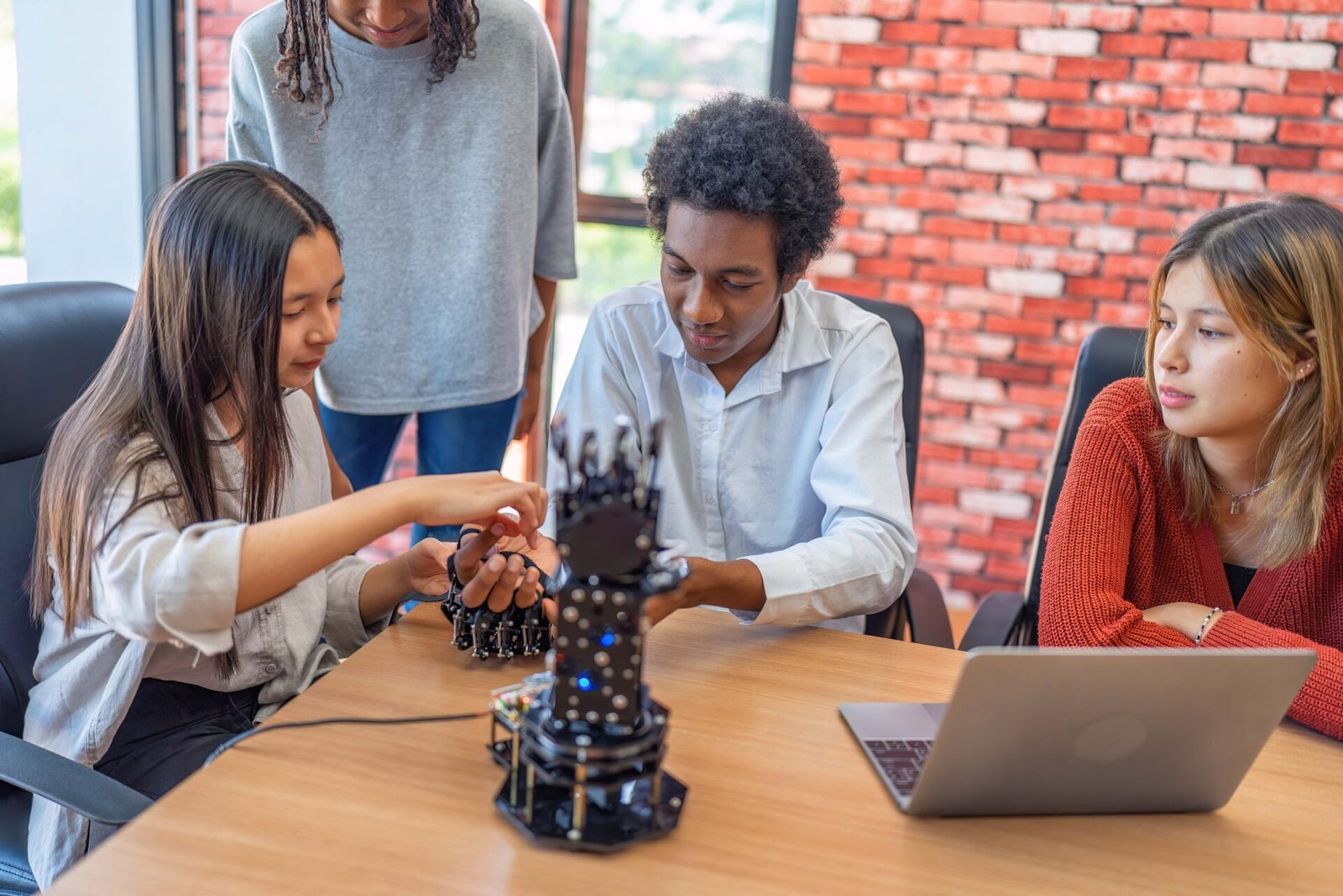 teenager-children-learning-with-new-innovation-robotic-hand-interface-hand-control-in-classroom