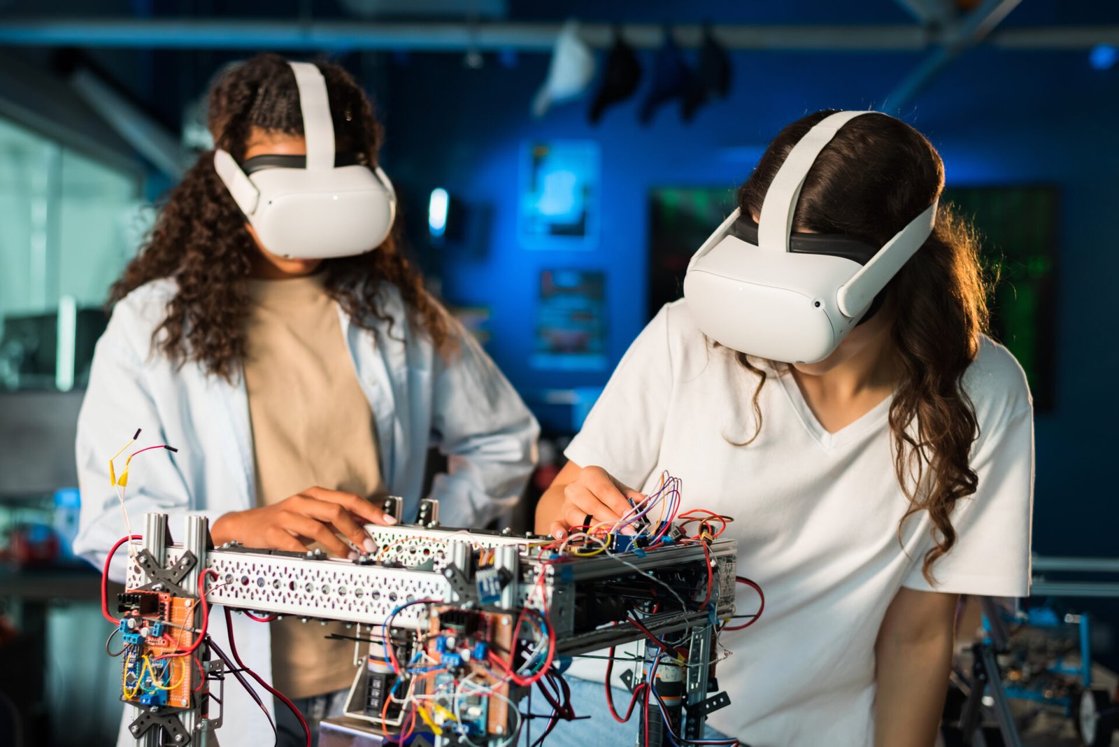 two-young-women-in-vr-glasses-doing-experiments-in-robotics-in-a-laboratory-robot-on-the-table